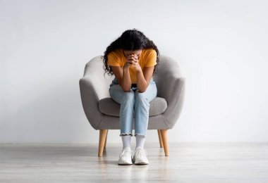 Life Problems. Portrait Of Despaired Lady Sitting With Head Down In Armchair