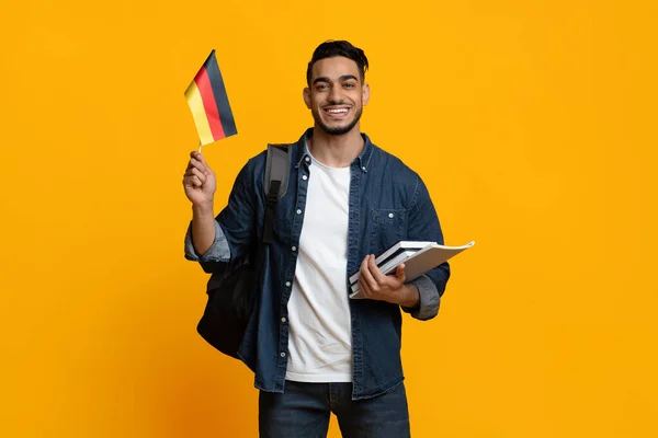 Happy arabic guy student showing flag of Germany — Foto Stock