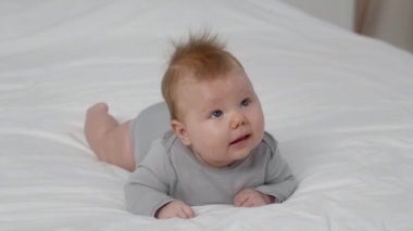 Baby Development. Cute Newborn Boy Lying On Bed On His Tummy