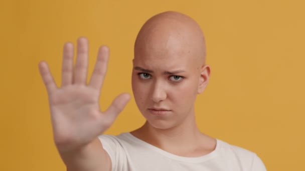 Άτριχη γυναίκα χειρονομώντας σταματήσει κουνώντας το κεφάλι πάνω από το κίτρινο φόντο — Αρχείο Βίντεο