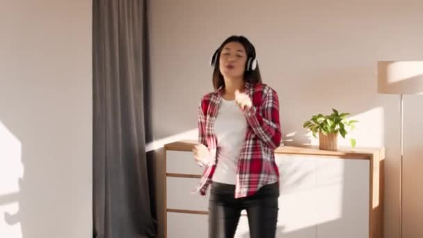 Cheerful Korean Millennial Lady Dancing Wearing Headphones Listening Music Indoor — Vídeo de Stock