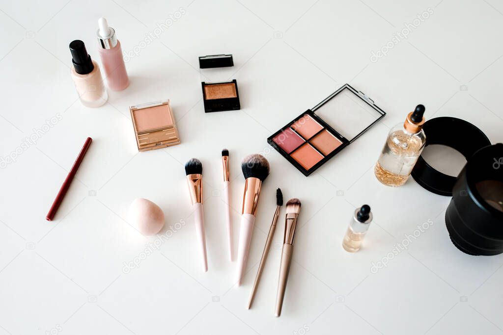 Above-View Of Cosmetic Products And Camera Lenses On White Background
