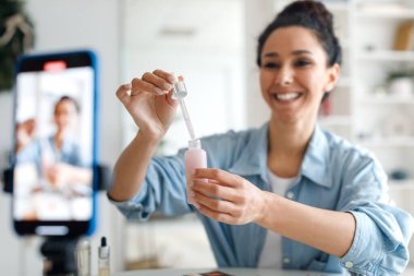 Female Beauty Blogger Making Video On Smartphone Using Cosmetics Indoor