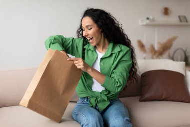 Joyful Customer Woman Unpacking Package After Successful Shopping At Home