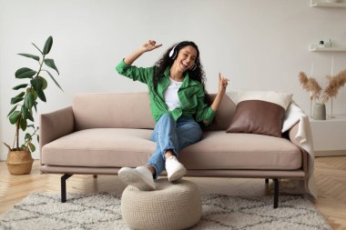 Joyful Female In Headphones Listening To Favorite Song Singing Indoor