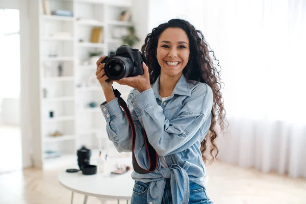 Happy Female Photographer Holding Photo Camera Taking Pictures Standing Indoors — Fotografia de Stock