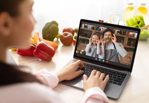 Woman Making Video Call To Husband And Daughter While Cooking In Kitchen — Stock Photo, Image