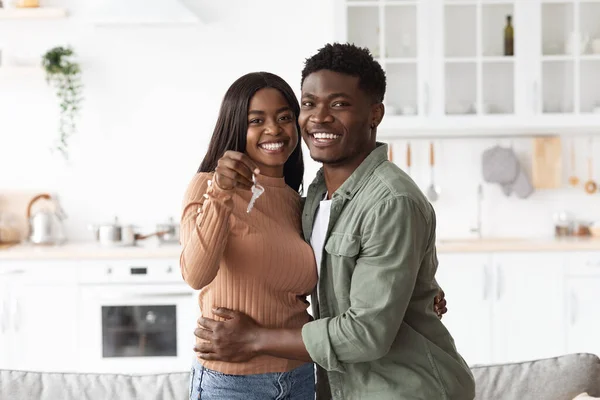 Excited african american young family showing keys to own home — 스톡 사진