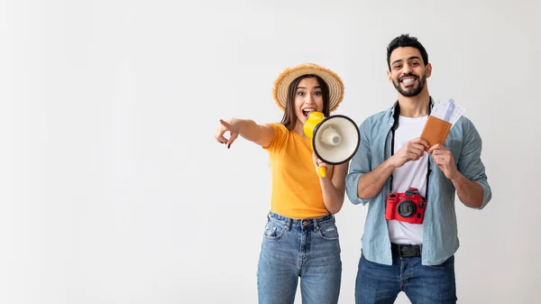 Great deals for tourists. Happy couple with megaphone announcing cool offer, panorama with free space — Stock Photo, Image