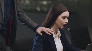 Cinsel tacize hayır. Şehvetli patron kadın asistanına dokunuyor, mutsuz kadın tacizi reddediyor.