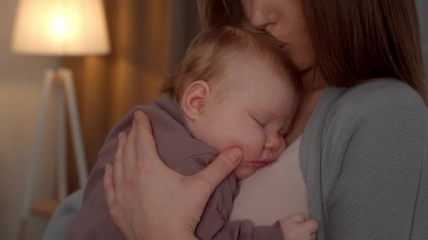 Mère aimante embrassant adorable nouveau-né dormant sur sa poitrine — Video