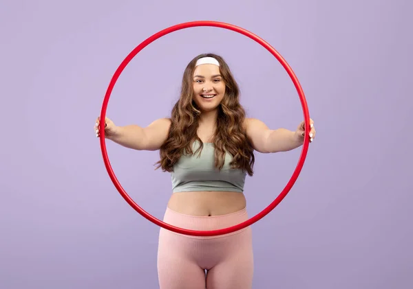 Glad happy caucasian plus size young woman in sports uniform hold hula hoop — Stock Photo, Image