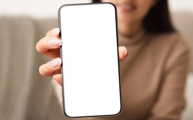 Kameraya yakın beyaz, boş akıllı telefon ekranı gösteren kadın