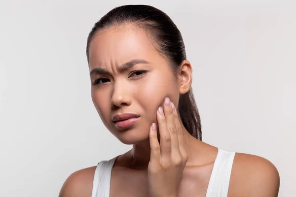 Unhappy asian lady experiencing strong wisdom tooth pain — Stock Photo, Image