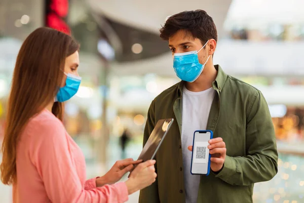 Lady With Tablet Scanning Code On Guys Smartphone In Hypermarket — Stock Photo, Image