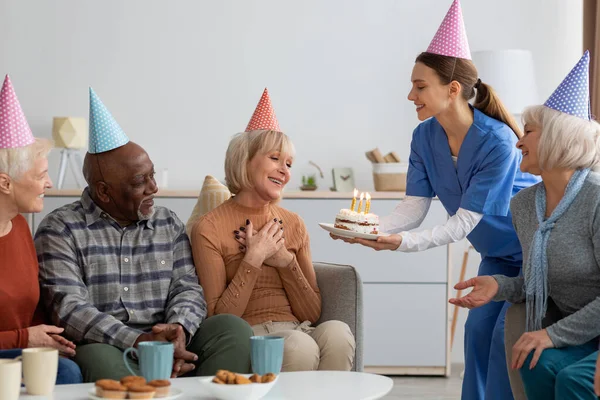 Starší žena má narozeninovou oslavu v pečovatelském domě — Stock fotografie