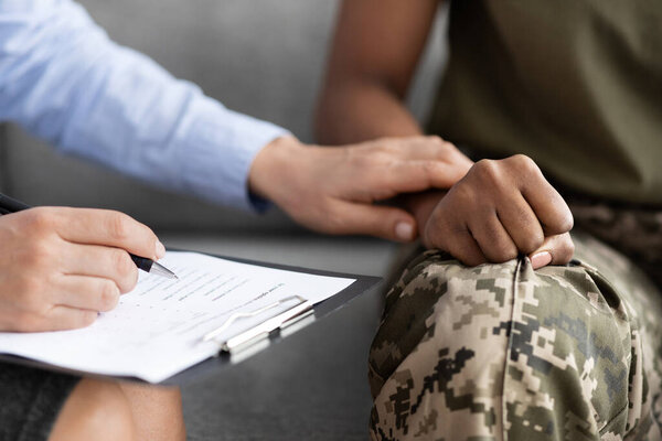 Closeup Shot Of Psychotherapist Supporting African American Soldier Woman During Therapy Session