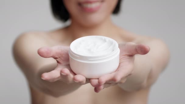 Unrecognizable Mature Asian Woman Holding Moisturizer Jar Over Gray Background — Stock Video