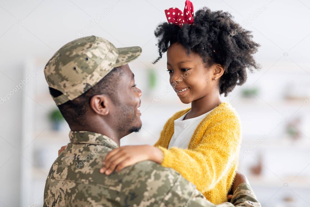 Happy Black Soldier Father And His Cute Little Daughter Embracing At Home