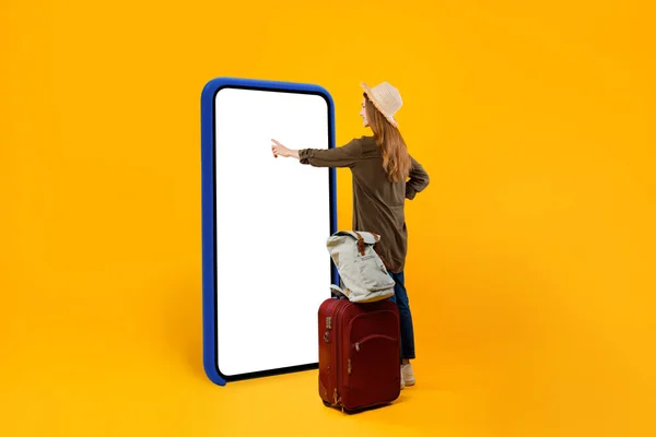 Reisenden mit riesigem Smartphone Touchscreen leeren Bildschirm, gelber Hintergrund — Stockfoto