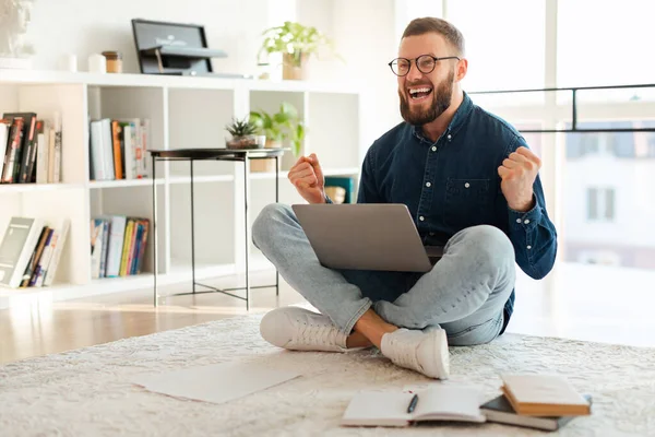Συναισθηματική Freelancer Man Φωνάζοντας Χρησιμοποιώντας Laptop Γιορτάζοντας την επιτυχία στο σπίτι — Φωτογραφία Αρχείου