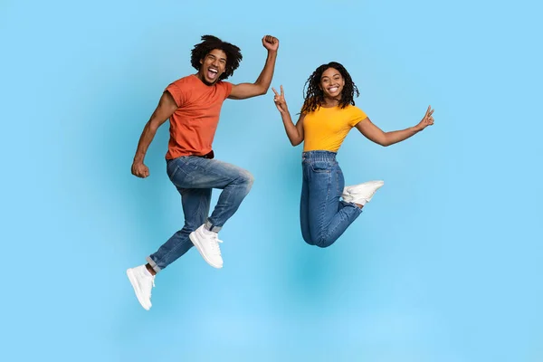 Carefree black lovers having fun on blue studio background — Stock Photo, Image