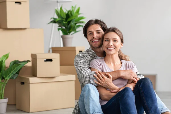 Vrolijke opgewonden millennial Kaukasische man en vrouw in casual knuffels, genieten van het verplaatsen op nieuwe flat — Stockfoto