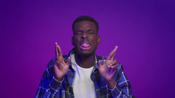 African American Man Crossing Fingers For Luck Over Purple Background — Stock Video