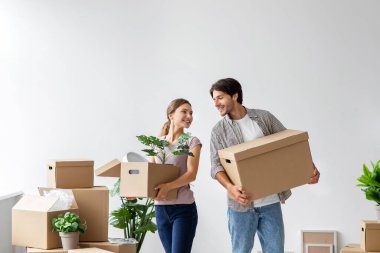 Kafkasyalı mutlu genç adam ve bayanın yeni kiralık evlerinde karton kutularla eğlenmesine sevindim.