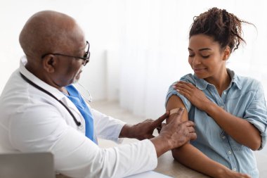 Hamile Siyah Kadın Aşı Oluyor, Doktor Yapışkan Bandaj Uyguluyor