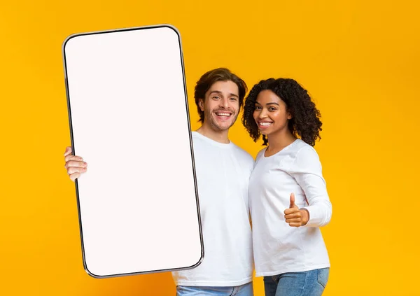 Couple Interracial montrant grand écran blanc vide smartphone et comme — Photo