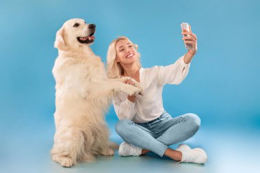 Köpeğiyle kendi portresini çeken genç bir kadın.