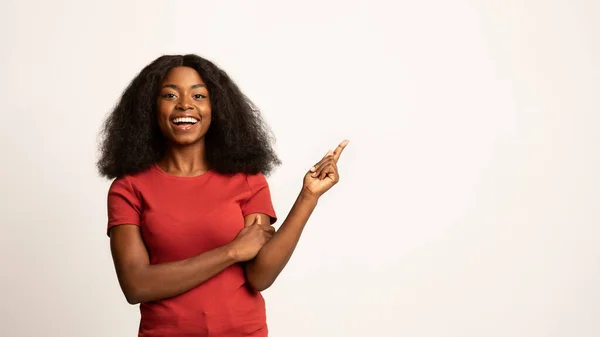 Mooi aanbod. Mooie glimlachende Afro-Amerikaanse dame wijzen aan de andere kant op Copy Space — Stockfoto