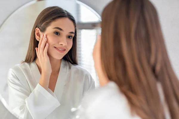 Bellezza naturale. Ritratto di attraente femmina sorridente al suo riflesso nello specchio — Foto Stock