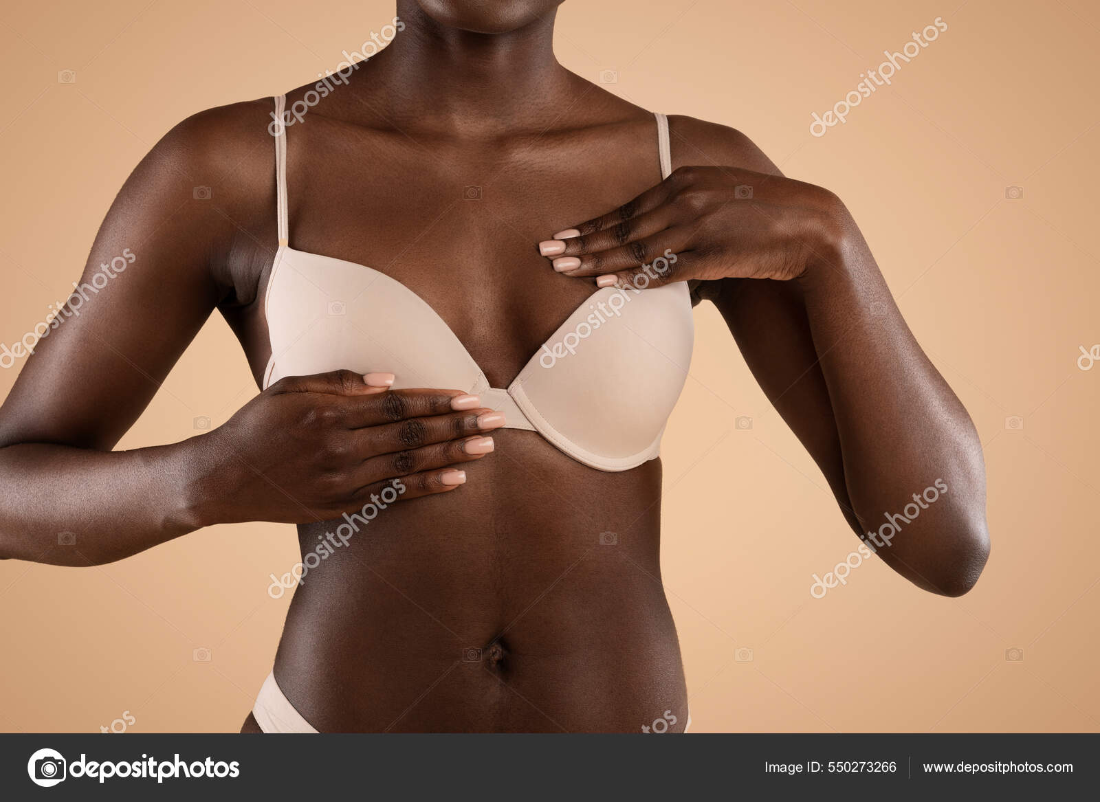 Breast screening concept. Black woman in bra rubbing her breast Stock Photo  by ©Milkos 550273266