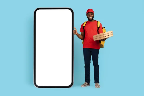 Handsome Black Delivery Guy With Pizza Boxes Standing Next To Blank Smarthone — Stock Photo, Image