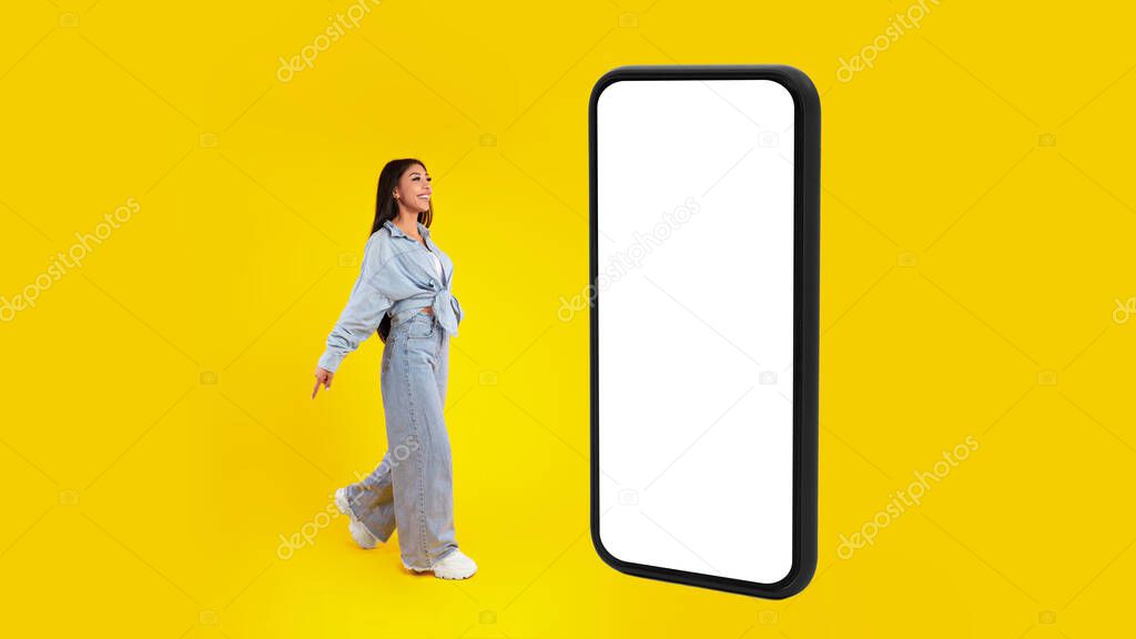 Woman standing near big white empty smartphone screen