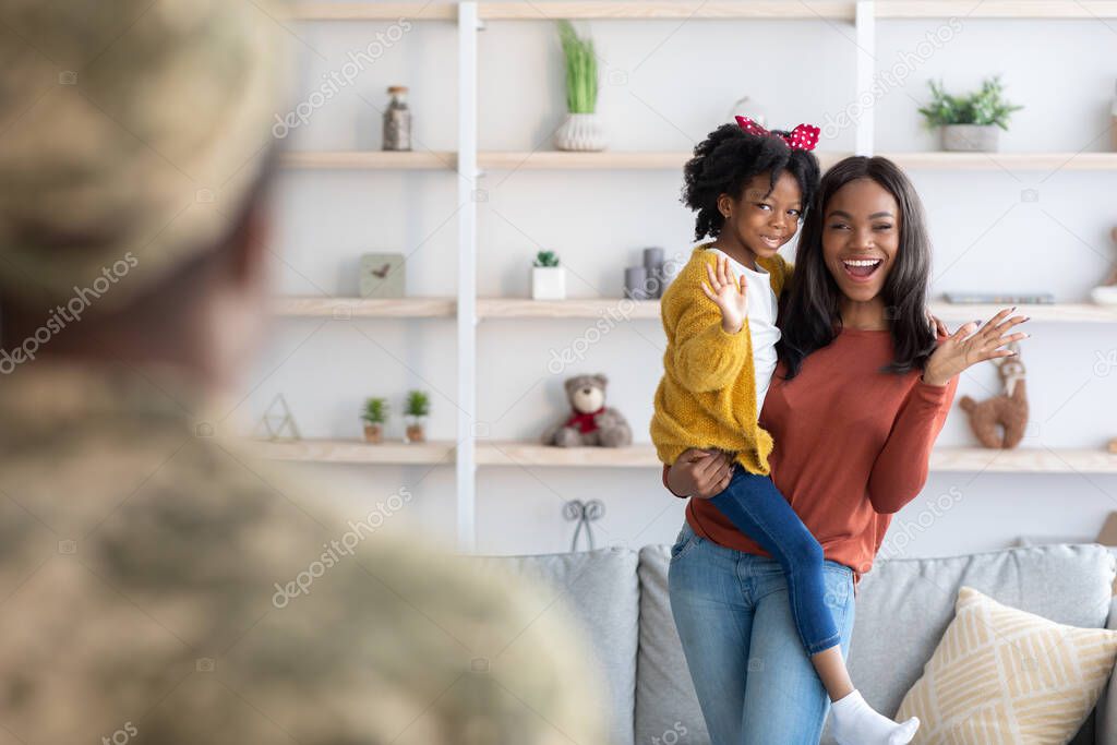 Joyful Young Black Wife And Little Daughter Welcoming Military Father At Home