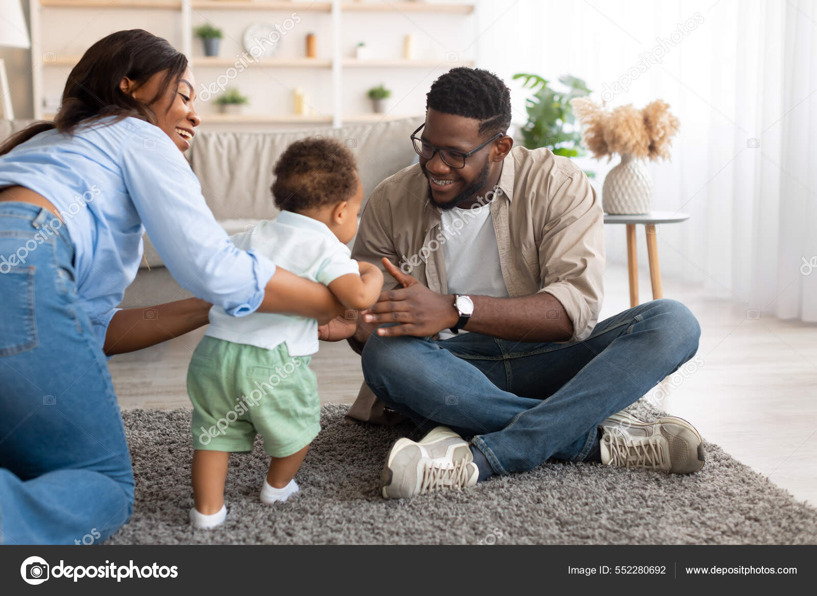 Black baby toddler walking in living room making first steps Stock Photo by  ©Milkos 552280692