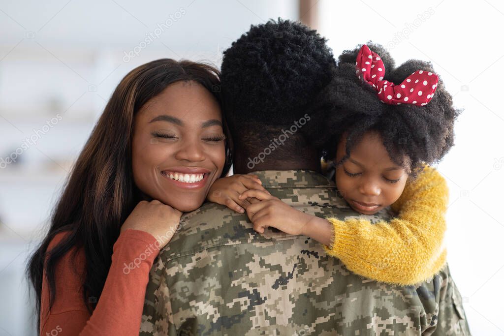 Happy Reunion. Joyful Wife And Daughter Hugging Military Man, Closeup