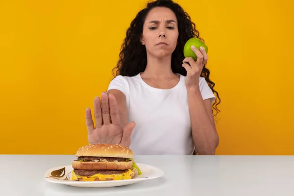 Portrait of Pensive Lady Holding Apple And Burger — Stock Photo, Image