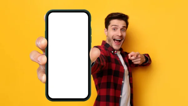 Opgewonden man wijst naar witte lege smartphone scherm — Stockfoto