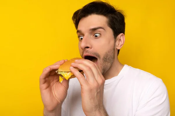 Funny Young Guy Holding Burger At Studio — Stock Photo, Image