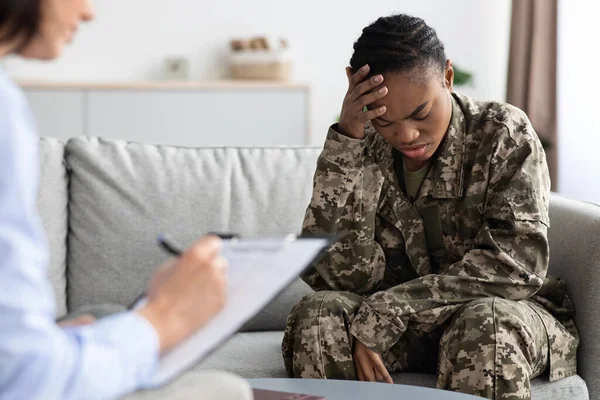 Depressed Black Soldier Woman Having Psychotherapy Session With Female Psychologist In Office