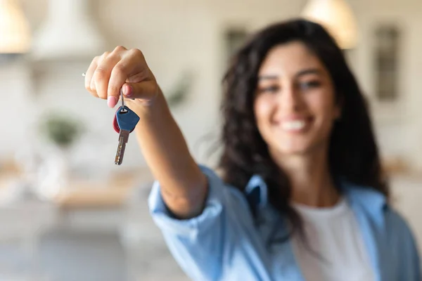 Cheery young woman holding apartment keys, purchasing or renting house, selective focus — Stock Photo, Image