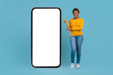 Harika bir uygulama. Güzel Afrikalı Amerikalı Kadın Büyük Boş Cep Telefonunu Gösteriyor