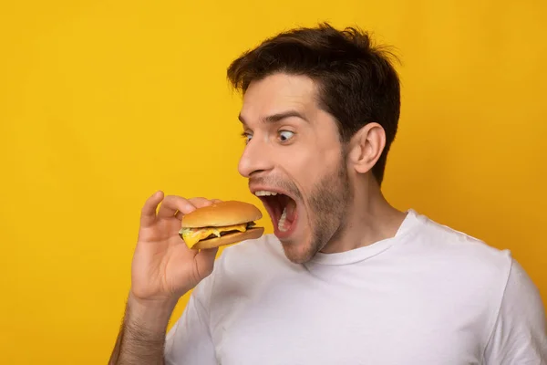 Funny Guy Holding Burger Biting Sandwich At Studio — Stock Photo, Image