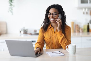 Neşeli zenci kadın bağımsız müteahhit evde çalışıyor.