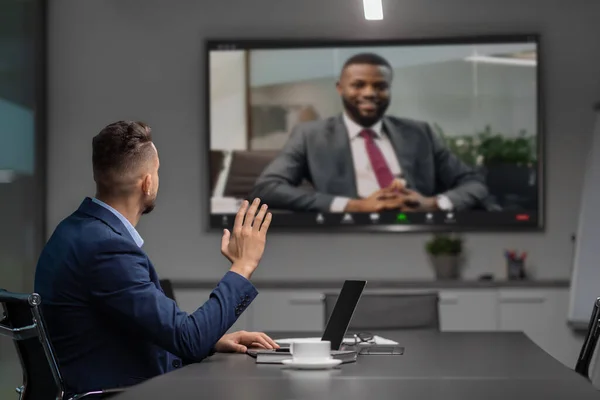 Middle eastern businessman having video conference with african american partner — Stock Photo, Image