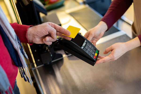 Cropped of male customer paying with credit card